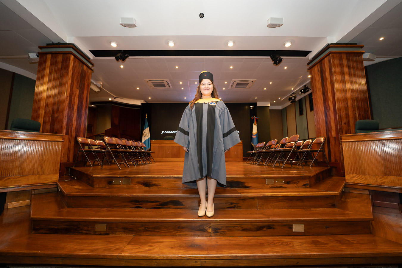 Graduanda en los escalones del aula magna de la UMG